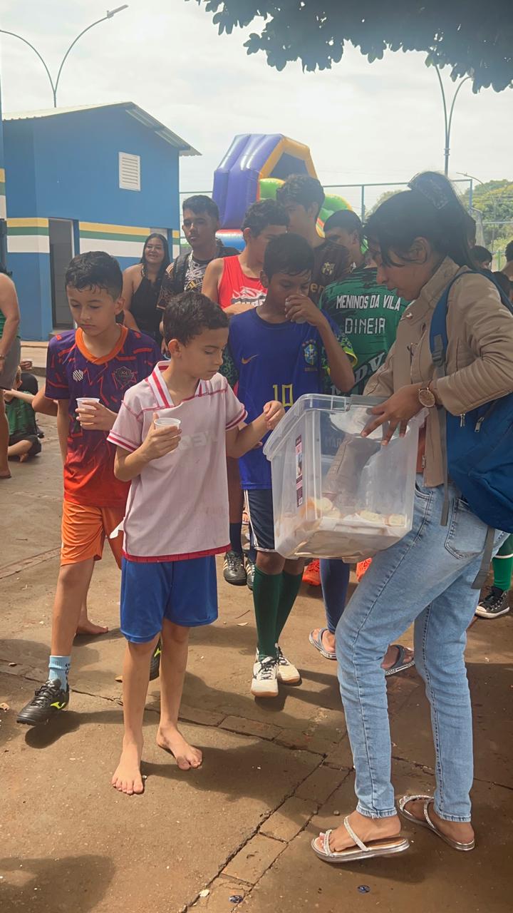 Voluntária distribui lanches às crianças